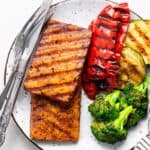 plate with grilled marinated tofu steaks, peppers, zucchini and broccoli
