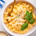 Overhead view of butternut squash mac and cheese in bowl with fork