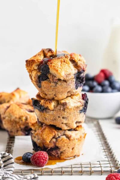 three french toast muffins stacked with syrup pouring over