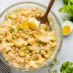 overhead of a glass bowl with creamy potato salad with eggs