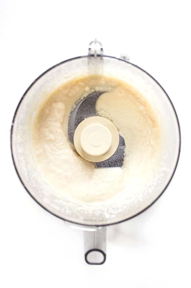Overhead view of coconut butter in a food processor