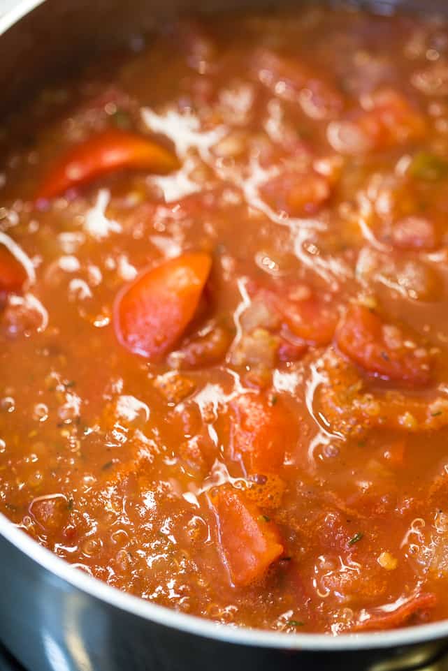 Unblended red pepper and tomato soup simmering with chunks of tomatoes