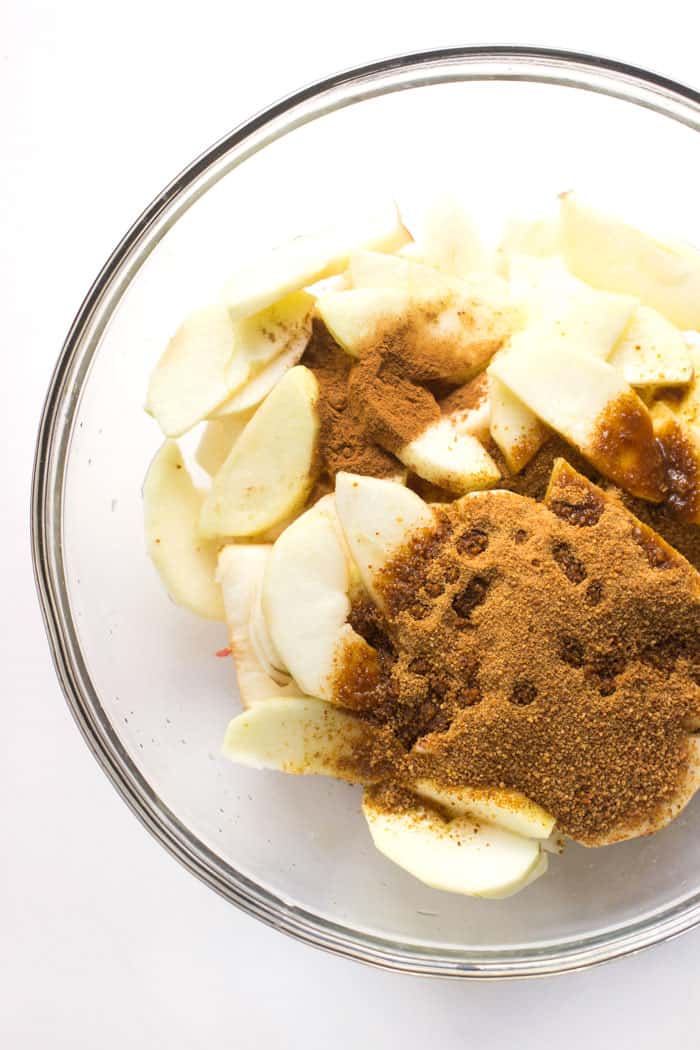 How to make apple crisp in the slow cooker. You start with just four simple ingredients: apples, coconut sugar, cinnamon and lemon juice.