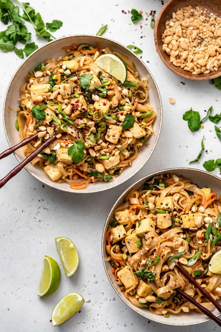two bowls of tofu pad thai with rice noodles