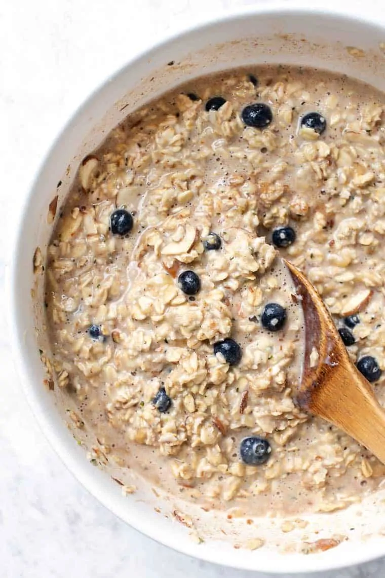 Bowl of oats with wooden spoon