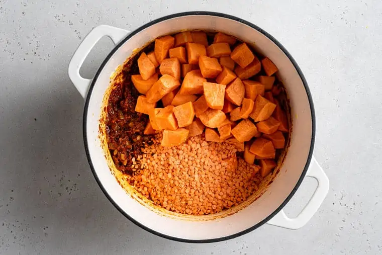 sweet potato and lentils in a pot with curry paste
