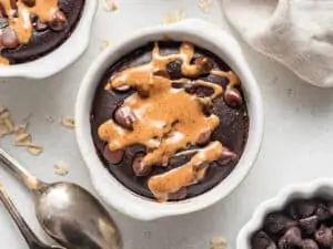 close up on a bowl of chocolate baked oatmeal with nut butter