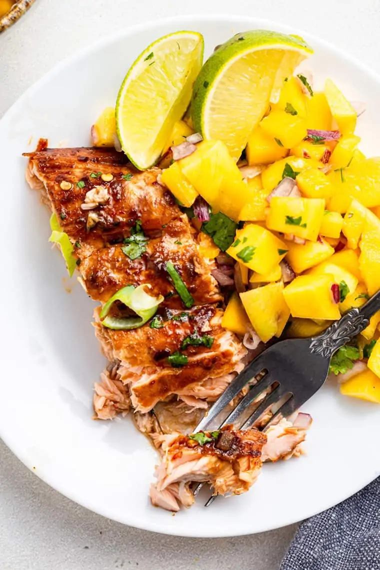 plate with a piece of salmon and mango salsa