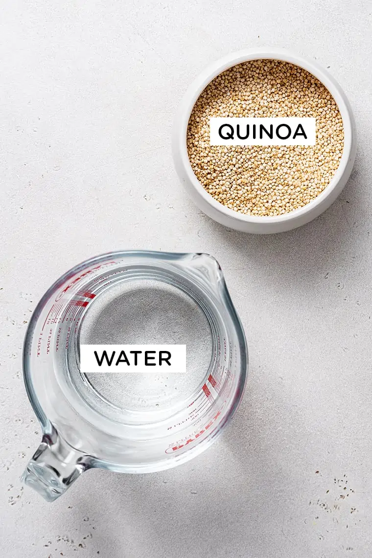 Overhead view of a pyrex of water and a bowl of uncooked quinoa, labeled. 