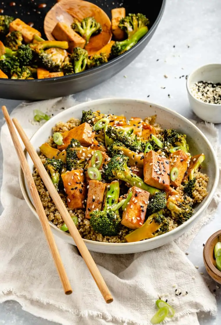 bowl of teriyaki quinoa stir fry with broccoli and tofu
